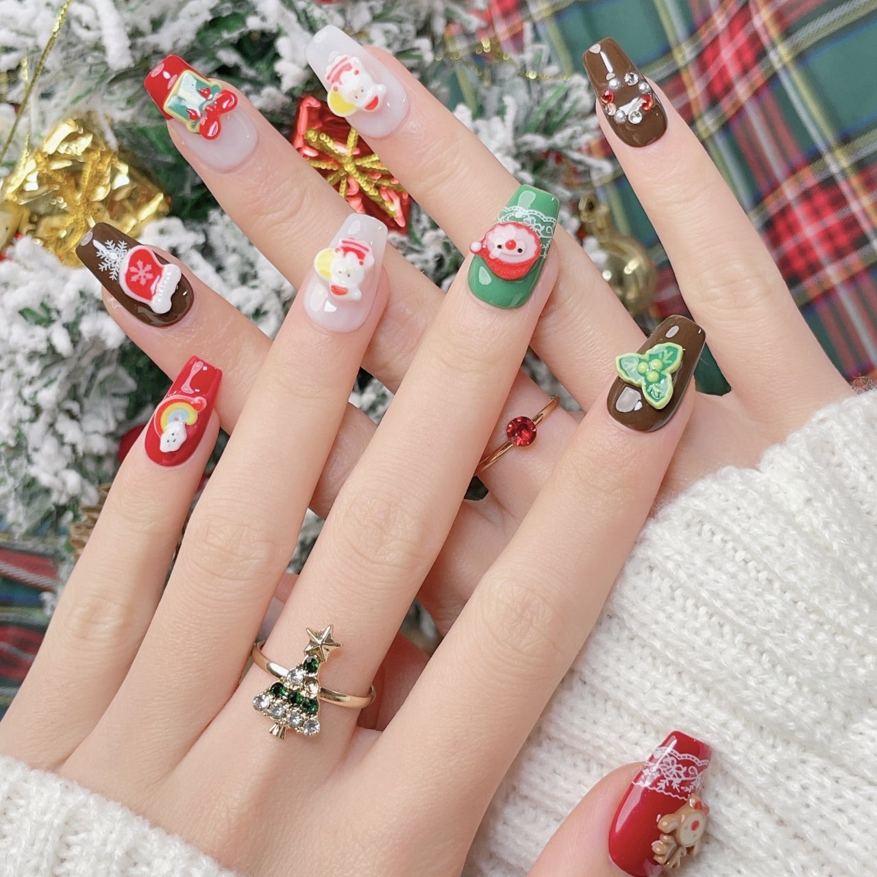 Festive Christmas-themed nails featuring detailed 3D designs, including Santa Claus, bows, snowflakes, and holiday ornaments, in red, white, brown and green colors, creating a joyful and celebratory look.