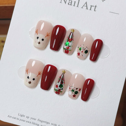 “Press-on nails featuring a charming Christmas theme with a detailed design of a deer and a Christmas tree. The deer is elegantly drawn,  adorned with ornaments and lights. The nails have a festive color palette, typically including red, green, and white, with a glossy finish, creating a holiday-inspired, whimsical, and cozy look.”