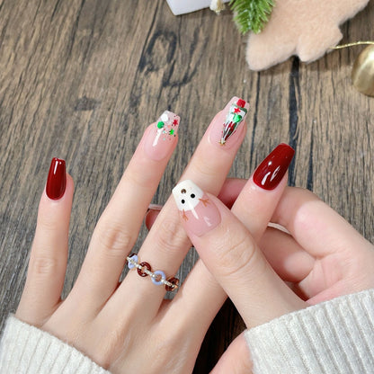 “Press-on nails featuring a charming Christmas theme with a detailed design of a deer and a Christmas tree. The deer is elegantly drawn,  adorned with ornaments and lights. The nails have a festive color palette, typically including red, green, and white, with a glossy finish, creating a holiday-inspired, whimsical, and cozy look.”